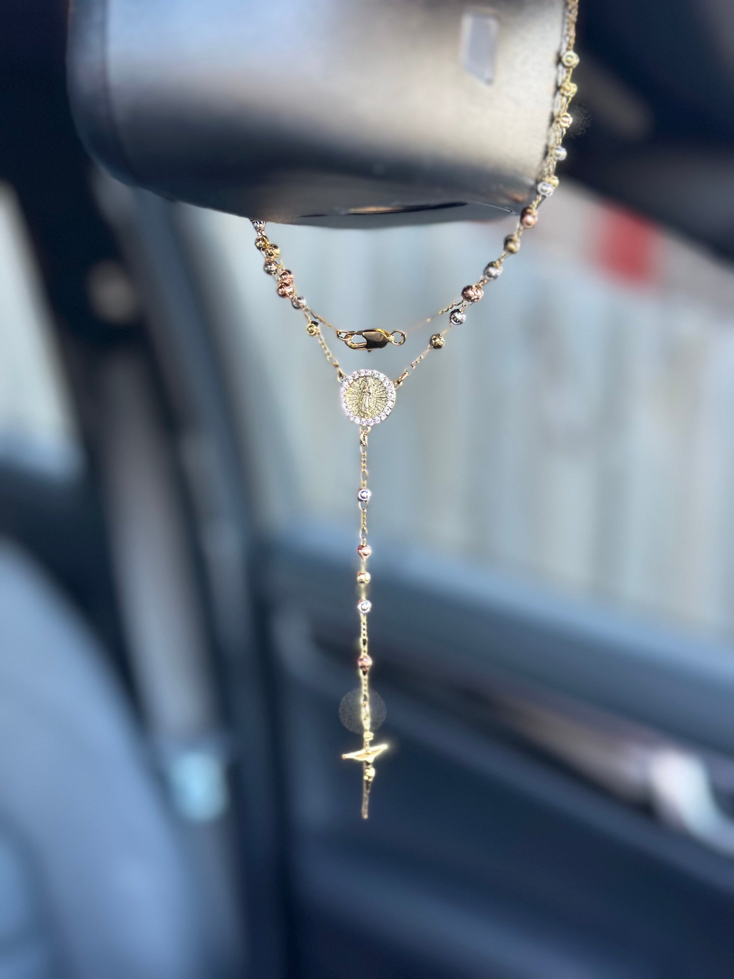rosary hanging in car