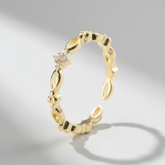 dainty Gold ring with diamond accents on a white background