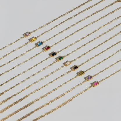 Gold bracelets with small colored birthstone gemstones for a personal gift