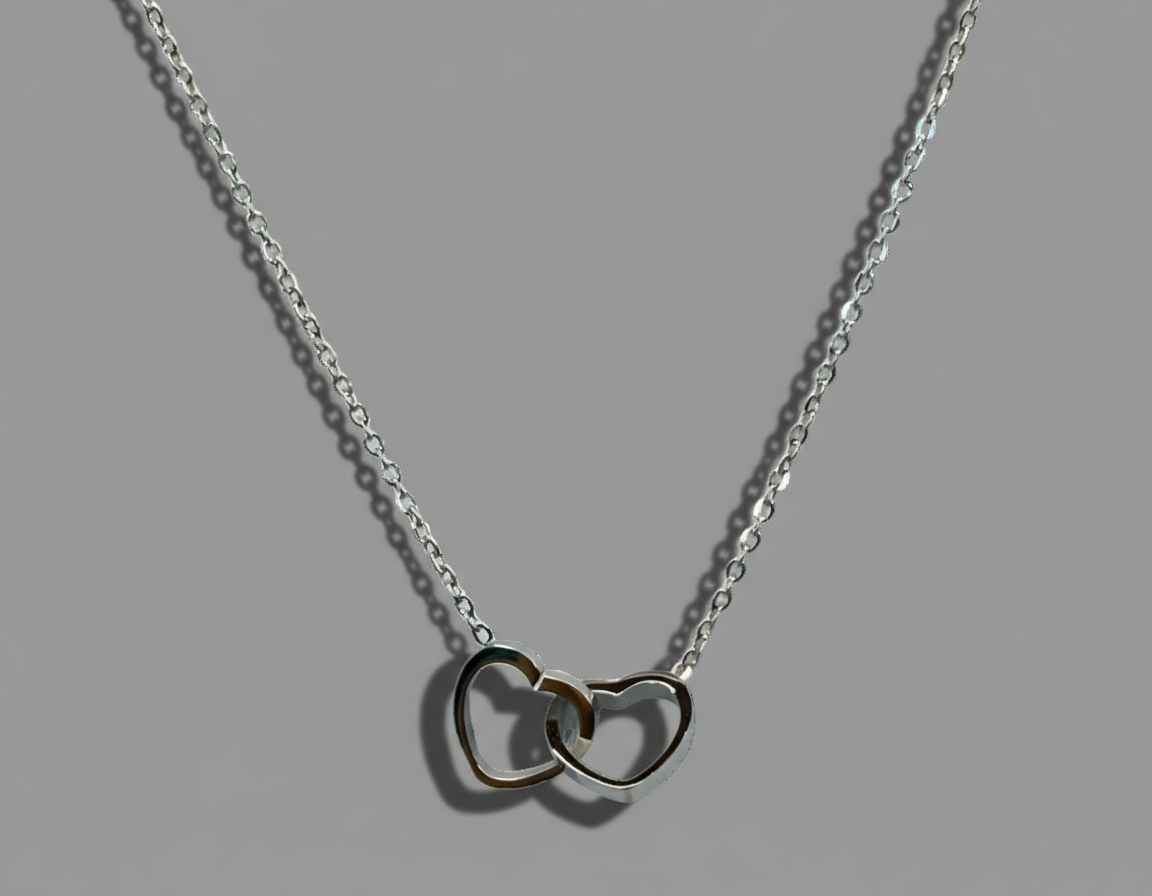 silver necklace made with stainless steel with two hearts intertwined 