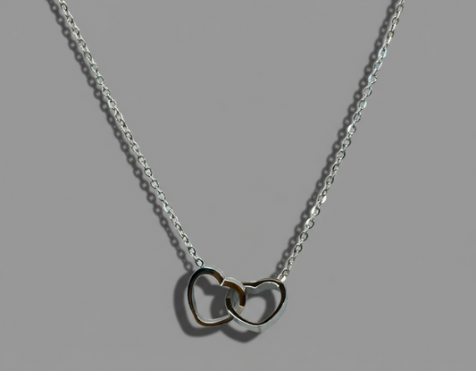 silver necklace made with stainless steel with two hearts intertwined 