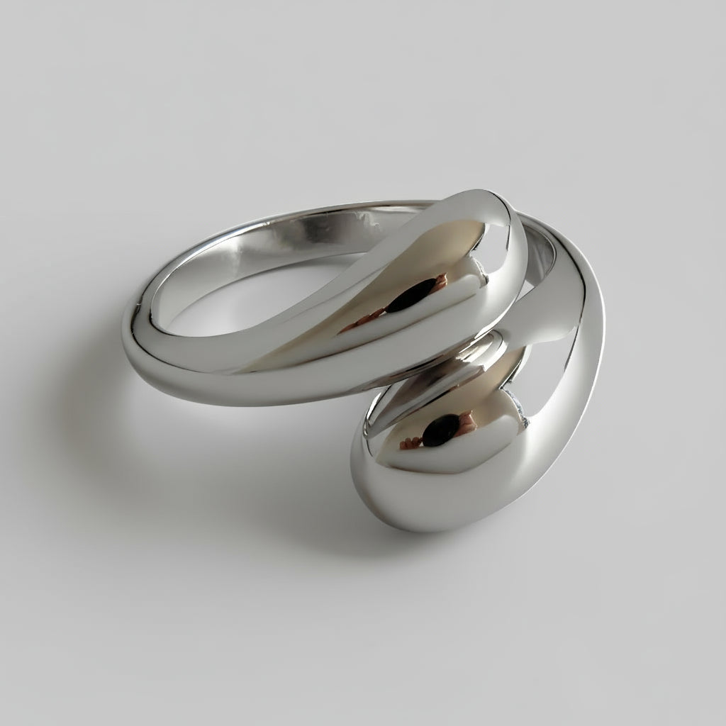 Silver ring with a modern design on a white background