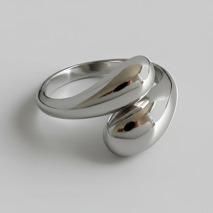 Silver ring with a modern design on a white background