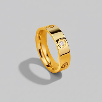 Gold ring with a diamond and x on it 