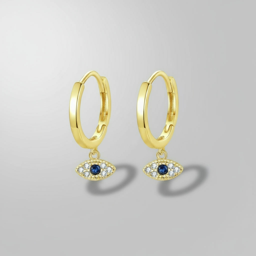 Gold hoop earrings with eye-shaped charms on a white background