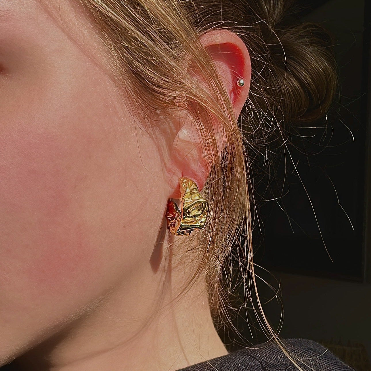 gold chunky earrings on model 