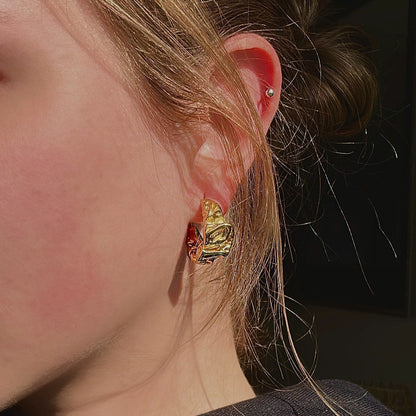 gold chunky earrings on model 