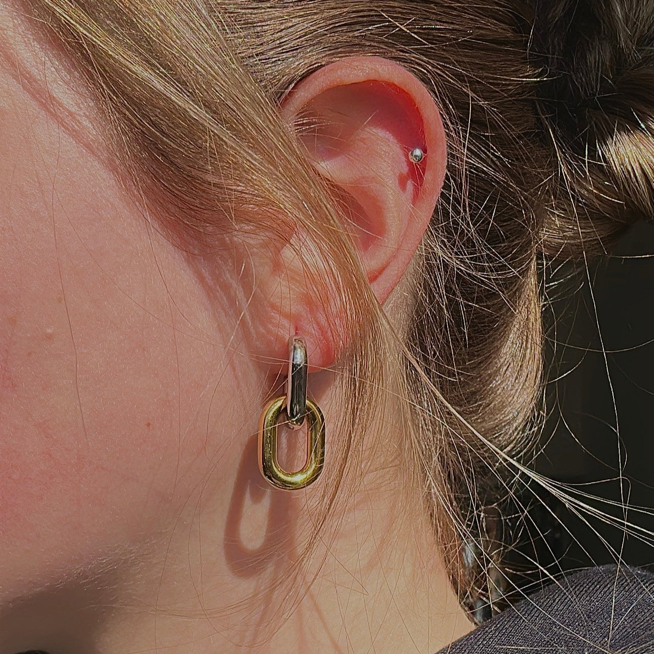 two tone earrings on model 