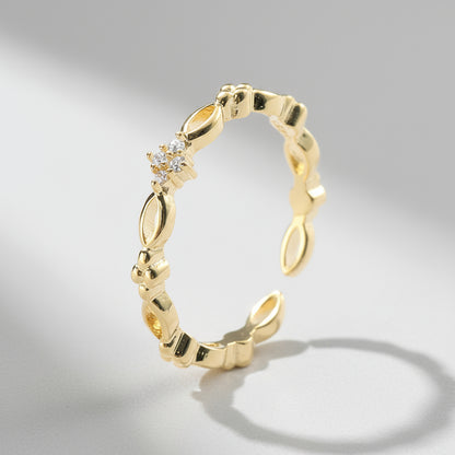 dainty Gold ring with diamond accents on a white background